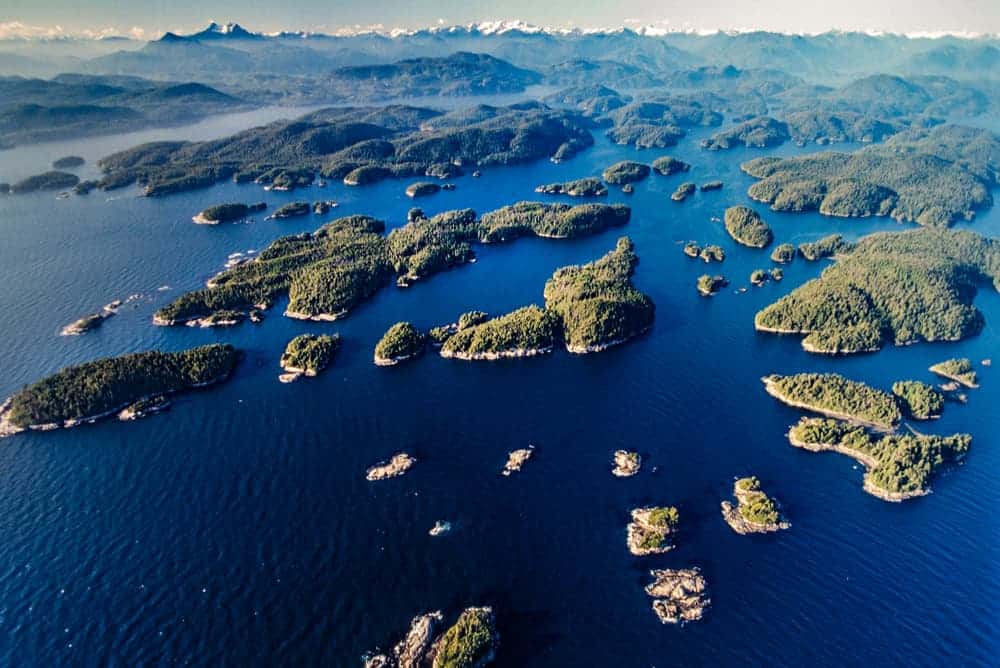 An aerial view of the Broughton Archipelago, a group of islands in a body of water, showcasing its beautiful ecotourism potential.