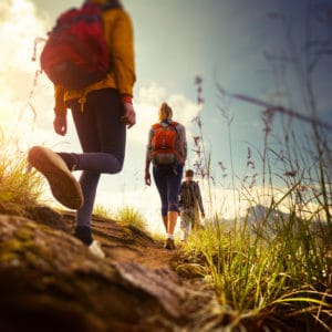 A group of people hiking on a trail in the mountains for National Public Lands Day.
