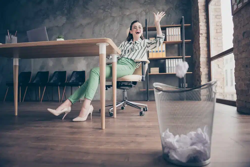 A woman sitting at a desk in Woodhall Spa, with a scrapped holiday park plans in front of her.