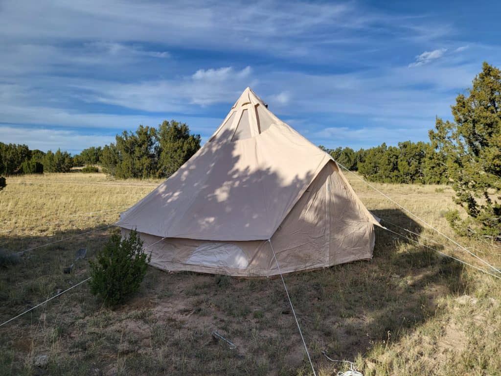 A teepee tent in the middle of a field at BLK Dream Camp.