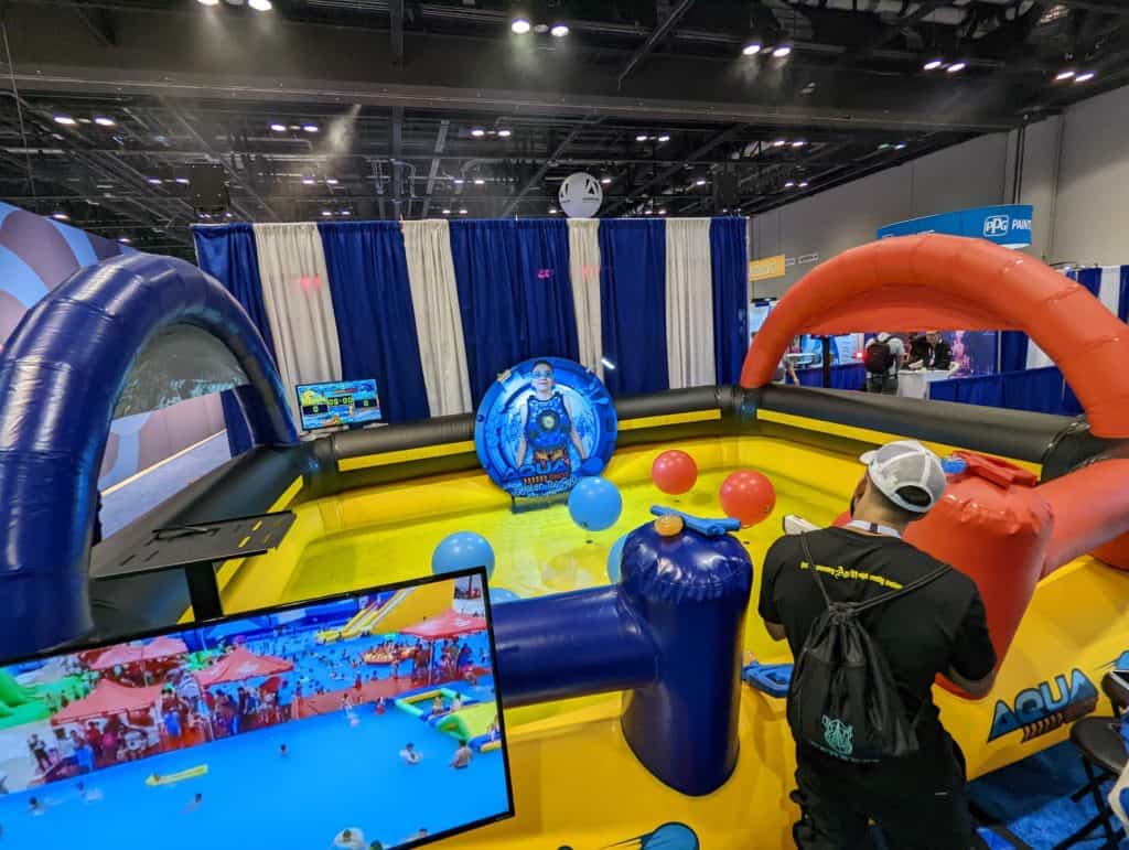 A group of people playing a game at the IAAPA Expo.