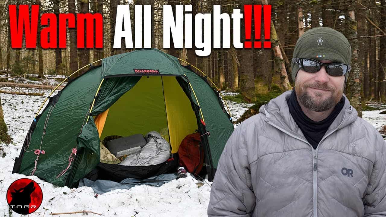 A man standing in front of a tent, ready to Stay Warm during Cold Weather with the words warm all night.