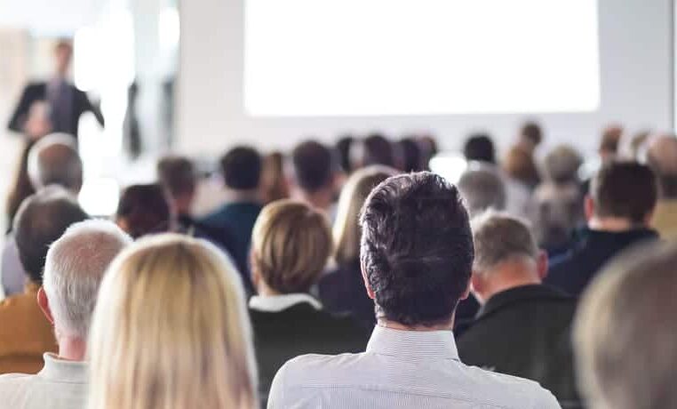 A group of people in an auditorium watching a presentation organized by BC Recreation.