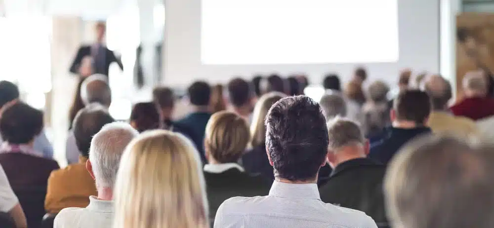 A group of people in an auditorium watching a presentation organized by BC Recreation.