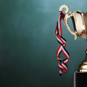 A gold trophy, representing an award nominations criteria, sits on top of a black background at the CCRCV.