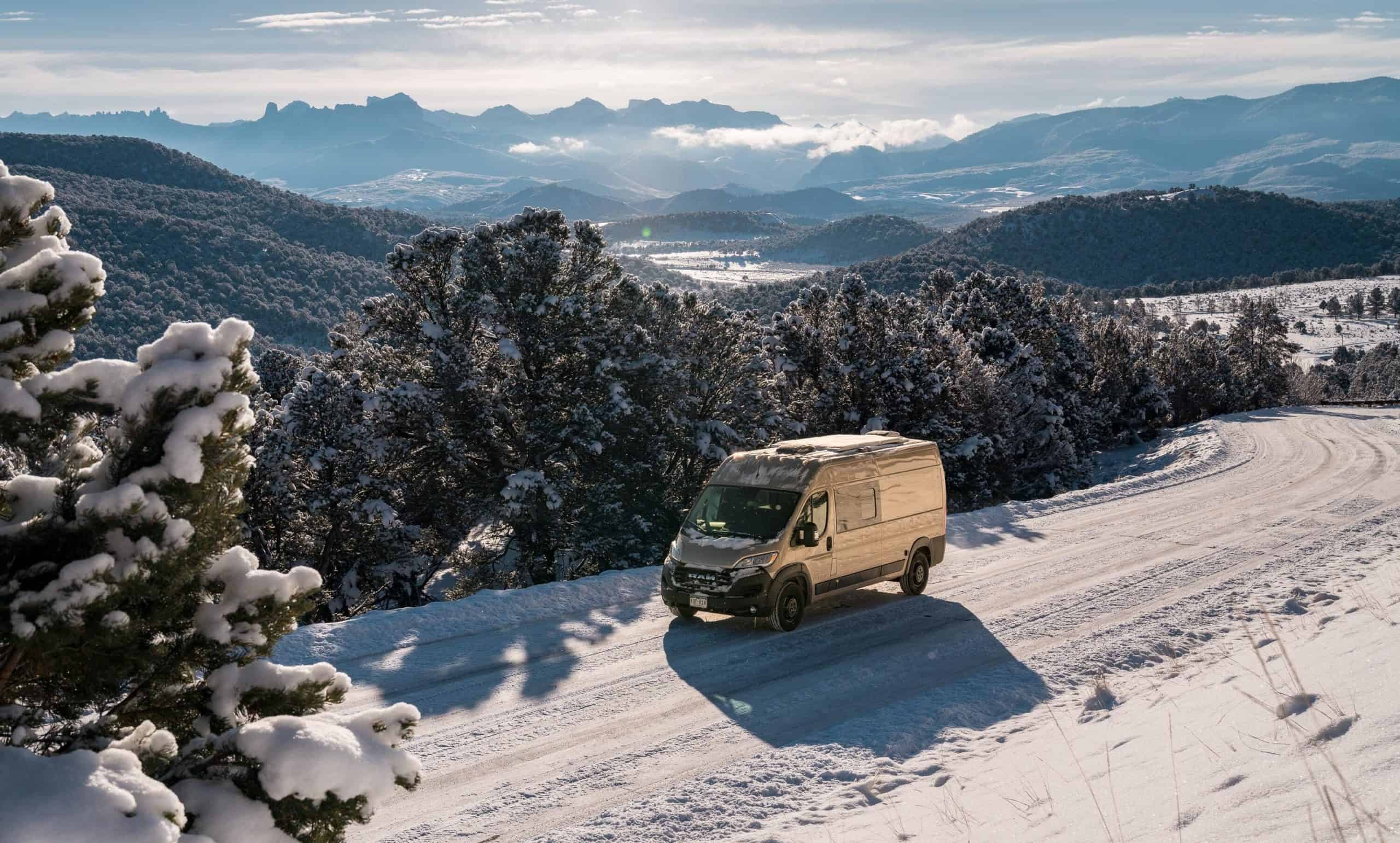 A Dave & Matt Van carefully navigates down a snowy mountain road on its way to the new facility it is relocating to.