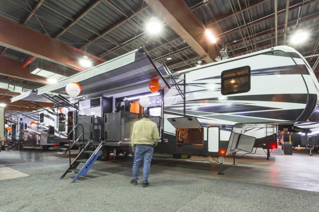 A man standing in front of a Red Deer RV during the Biggest Little RV Show.