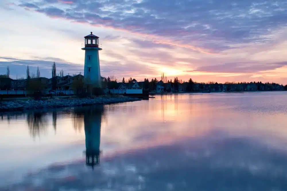 A lighthouse is reflected in the water at Sylvan Lake, Alberta Gov't.