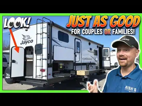 A man is standing in front of a Jayco RV, with a sign saying just as good for couples and families.