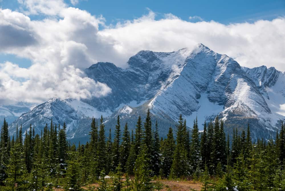 A development in Kananaskis Country offers glamping options with snow capped mountains in the background.