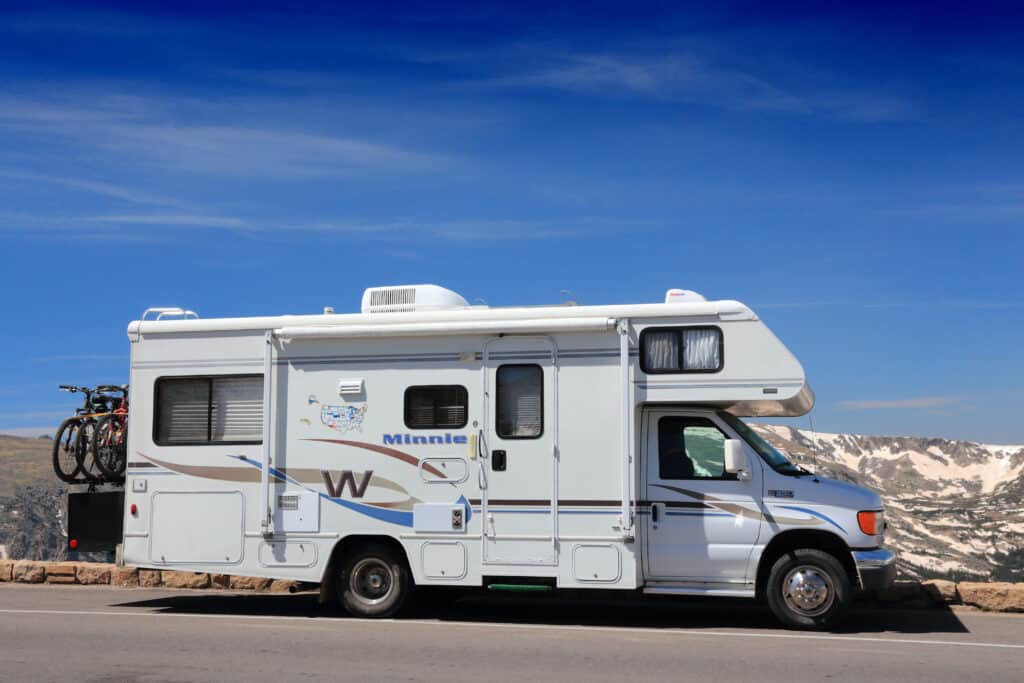 A Winnebago Industries RV parked on the side of the road.