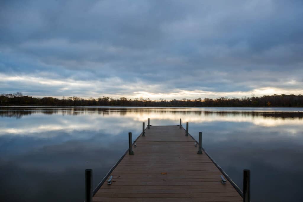 A dock on Ottawa Metro Park lake with a cloudy sky.