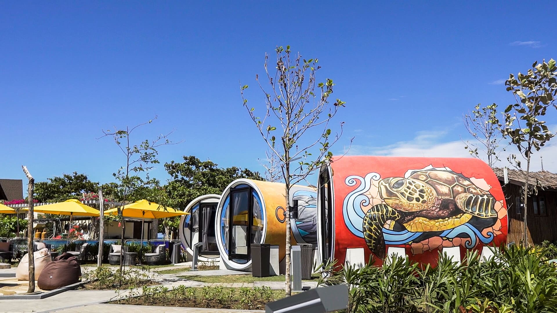 An Unconventional building with a colorful mural on it.