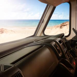 The interior of a van with a view of the beach, showcasing the captivating scenery and creating a perfect setting for Sun Communities' Q1 2023 Results that have exceeded expectations.