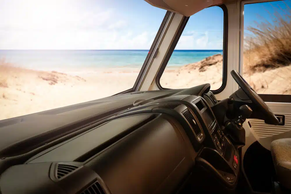 The interior of a van with a view of the beach, showcasing the captivating scenery and creating a perfect setting for Sun Communities' Q1 2023 Results that have exceeded expectations.