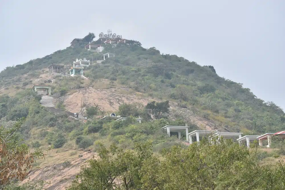 The top of a hill with stairs leading up to a Boluvampatti temple in the Reserve Forest.