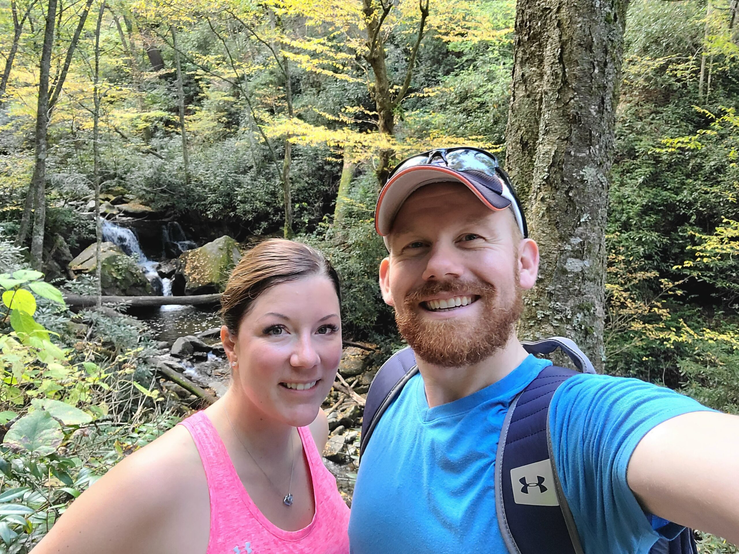 A Michigan couple taking a selfie on their journey through the woods while exploring a glamping business.