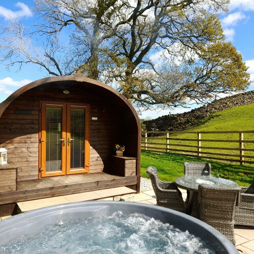 A hot tub in a wooden cabin in the countryside at Flakebridge Farm, UK.