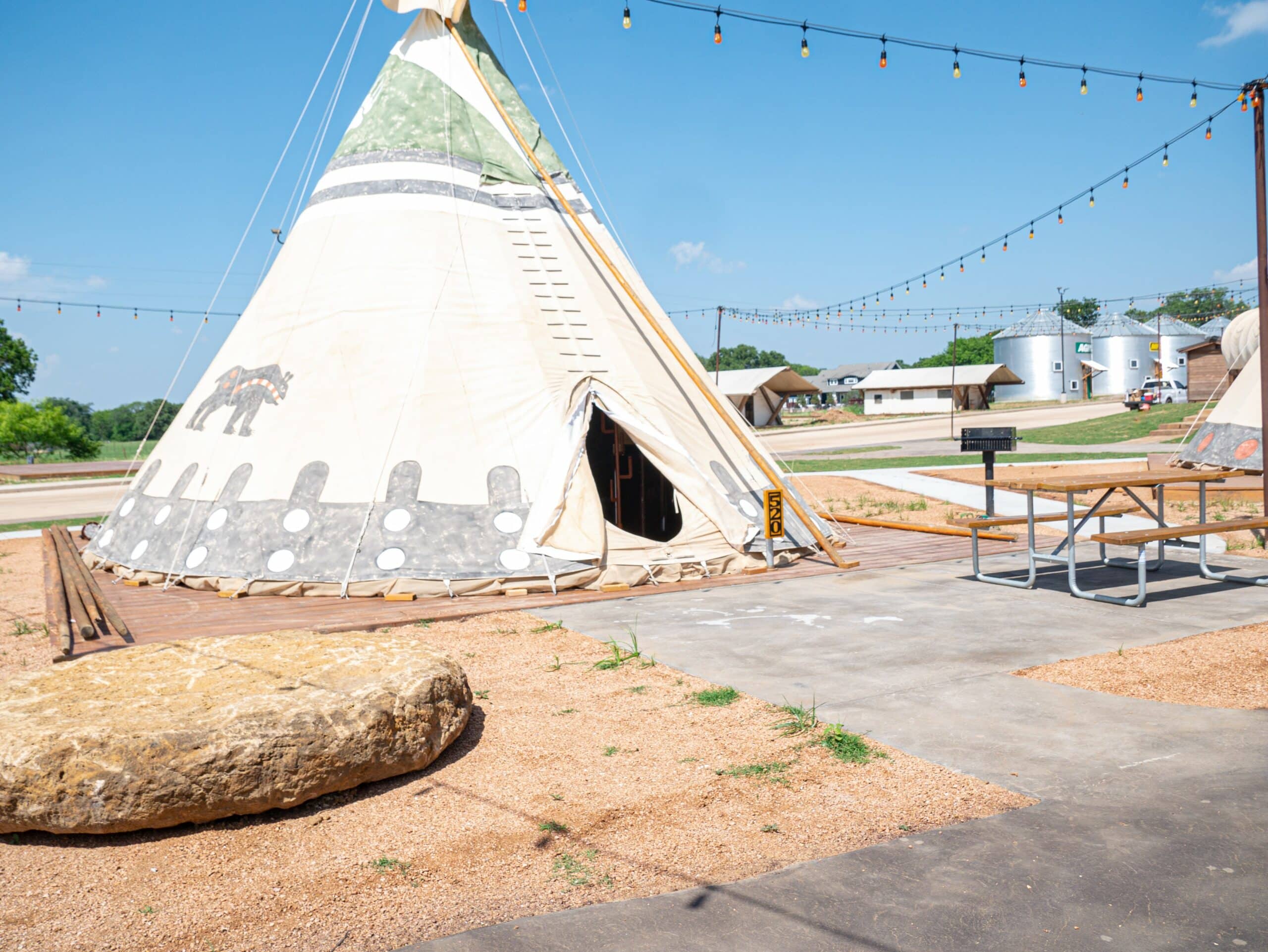 A teepee with a table and chairs in North Texas Jellystone Park, following the expansion.