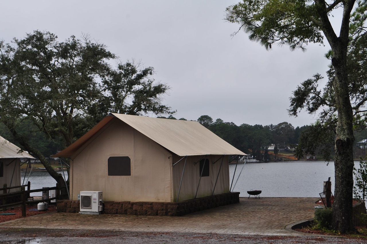 A tan tent on the side of Twin Lakes Camp Resort, an outdoor hospitality destination known for its awards.