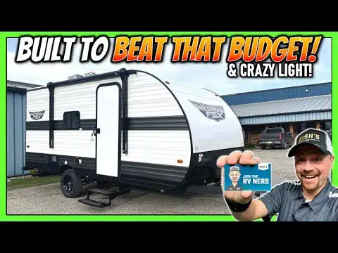 A man is holding up a picture of an RV, specifically the FSX 174BHLE model, showcasing its functionality and affordability. The words "built to beat that budget" perfectly capture