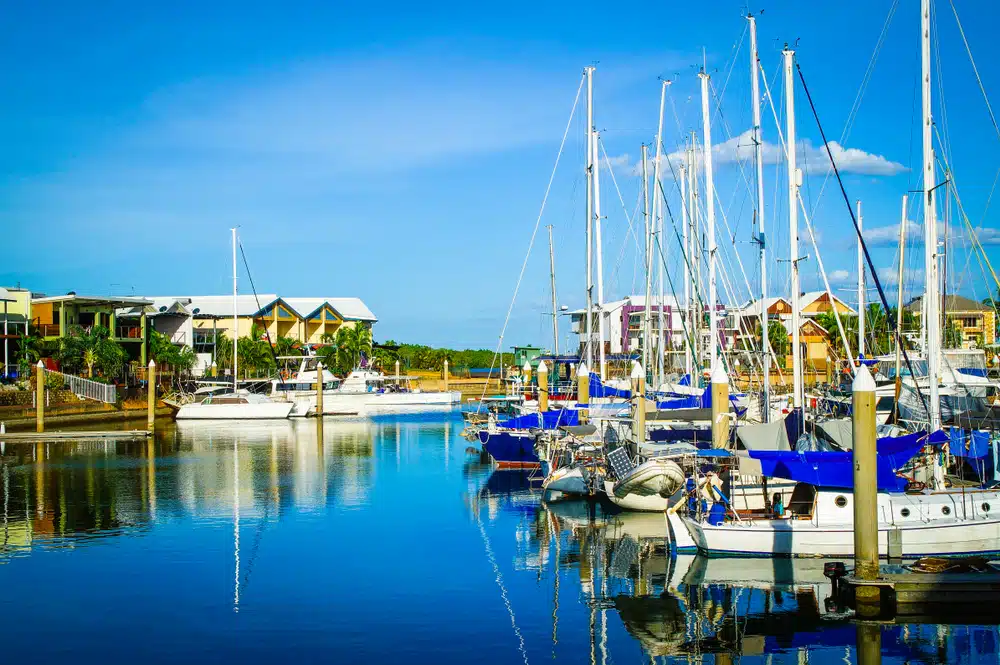 Several sailboats docked in a marina showcasing the challenges of high costs in Northern Territory Tourism.