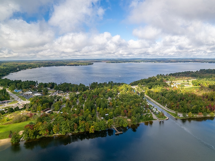 An aerial view of Mitchell State Park, including a picturesque lake and the charming small town nearby.