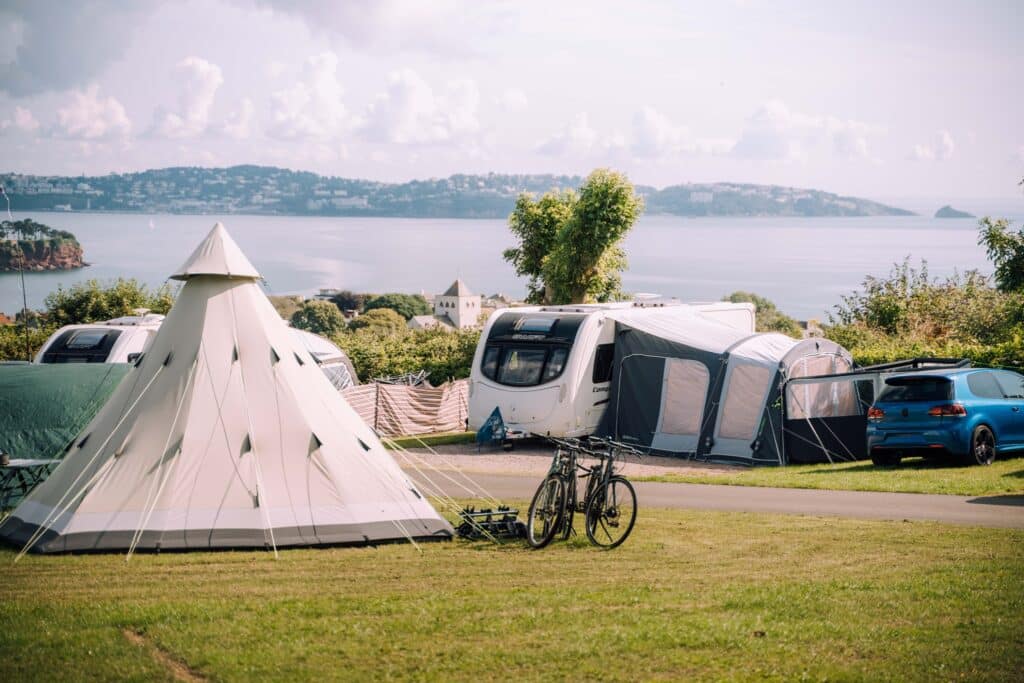 A premier holiday destination in South Devon, Beverley Park offers a unique experience with a teepee tent and a bicycle parked next to it.