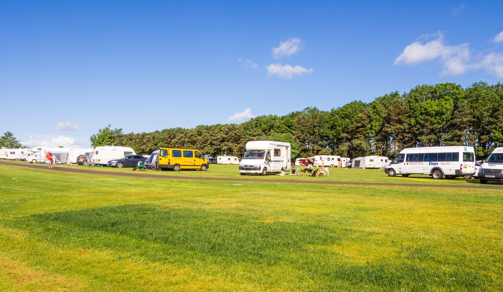 A group of rvs parked in a Northumberland field during opening days for pop-up campsites.