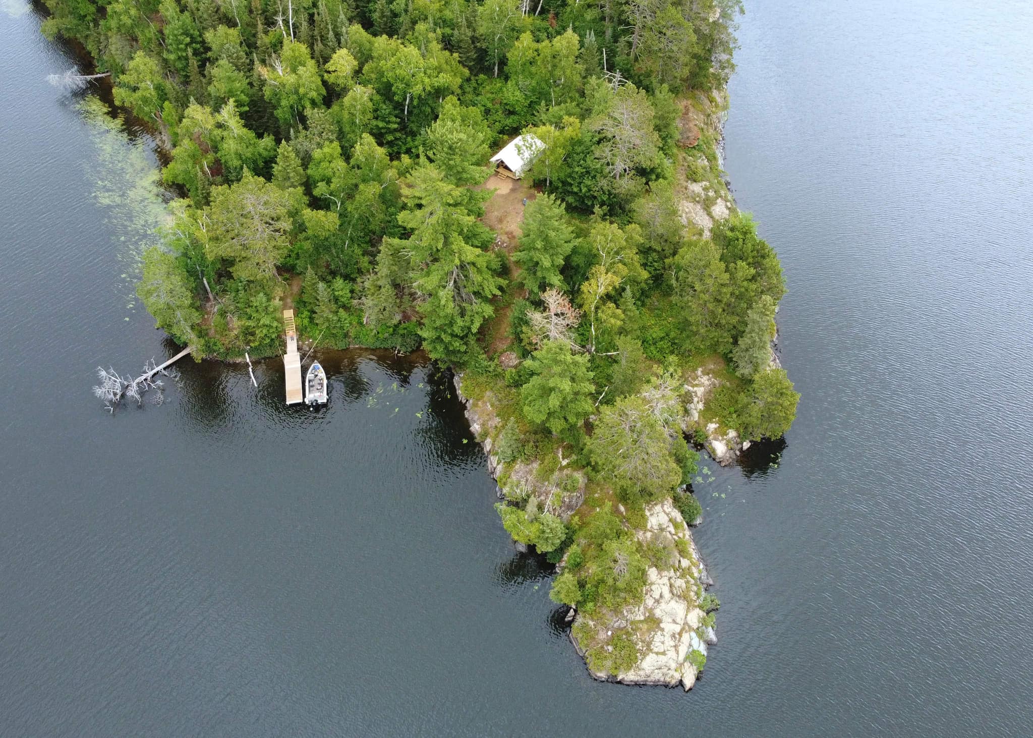 An aerial view of the Rough-N-It Campground, a small island in the middle of a lake.