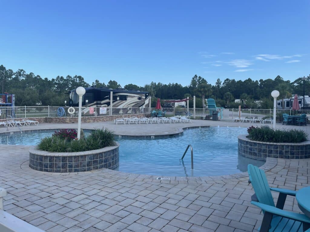 Sugar Sands RV Resort, with a perfect Good Sam Rating, now has a pool and lawn chairs for relaxation.