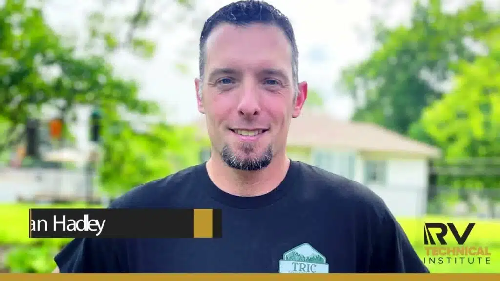 A Mobile RV Technician in a black shirt with the words in tadley.