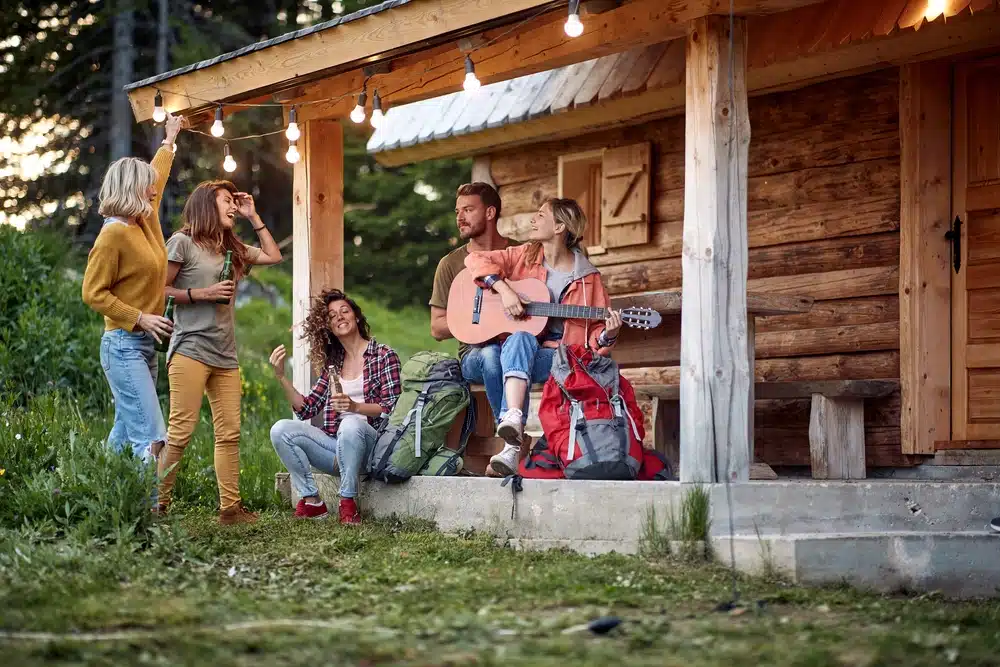 Mid-season campers enjoying the New England scenery on the porch of a cabin.