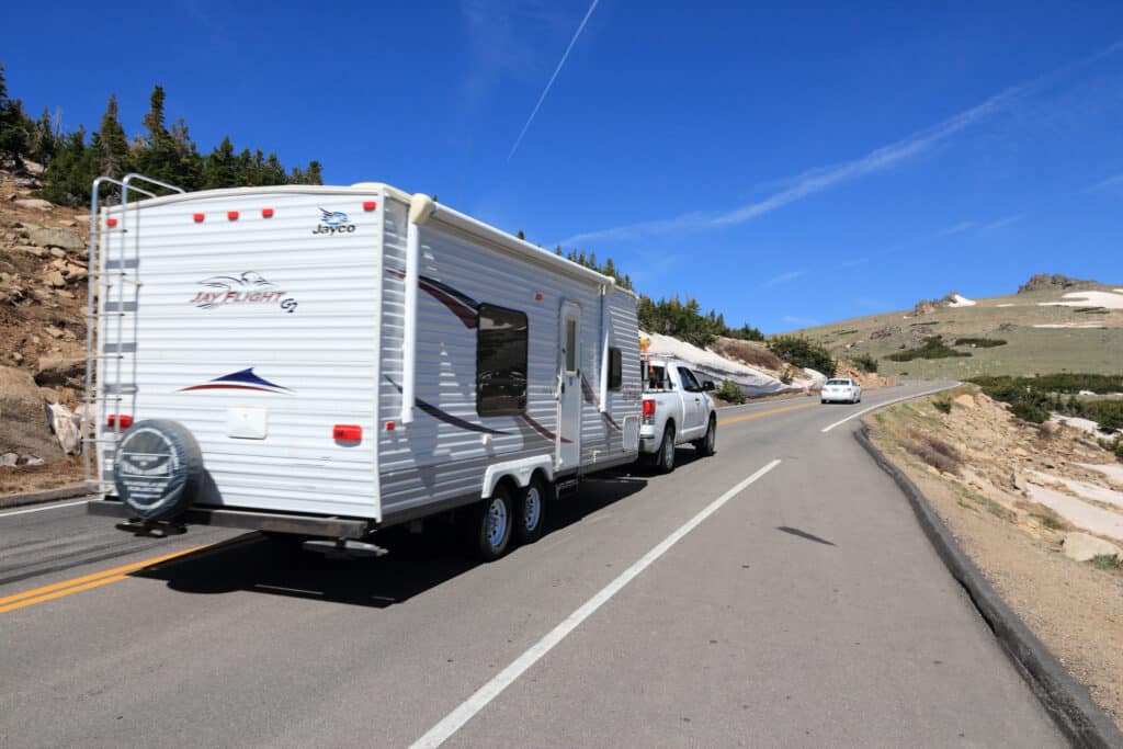 A white Jayco RV parked on the side of the road, showcasing local tourism and potential as a great escape for 2023.