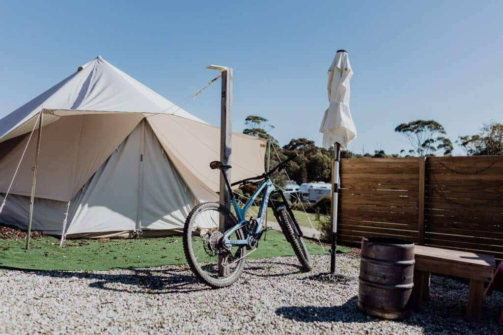 A tent with a bike parked in front of it at Tasmania's Coastal Gem, Scamander Sanctuary Holiday Park.