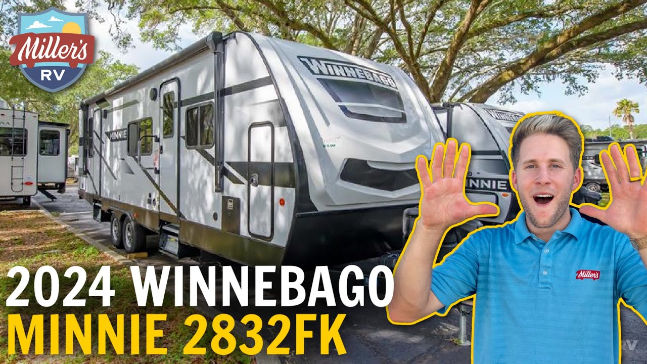 A man is holding up a Winnebago Minnie 228FK.