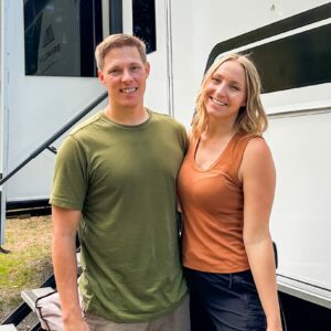 A man and woman standing in front of an RV during MC Fireside Chats on October 25th, 2023.