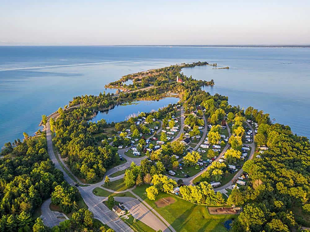 An aerial view of Tawas Point State Park, a popular RV park near the water.