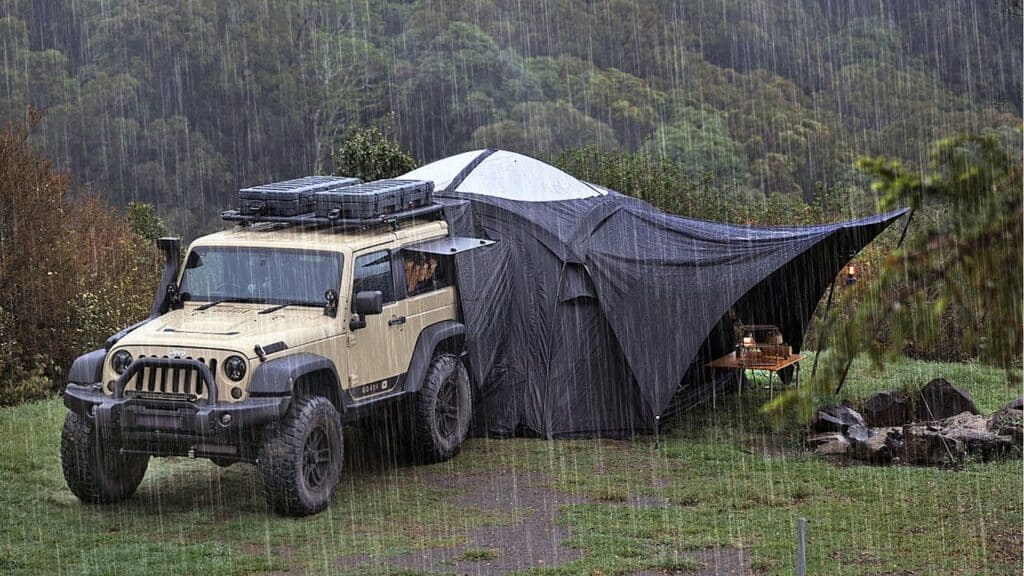 A solo adventure in Maleny, with a jeep parked under the rain, equipped with a car tent for camping.