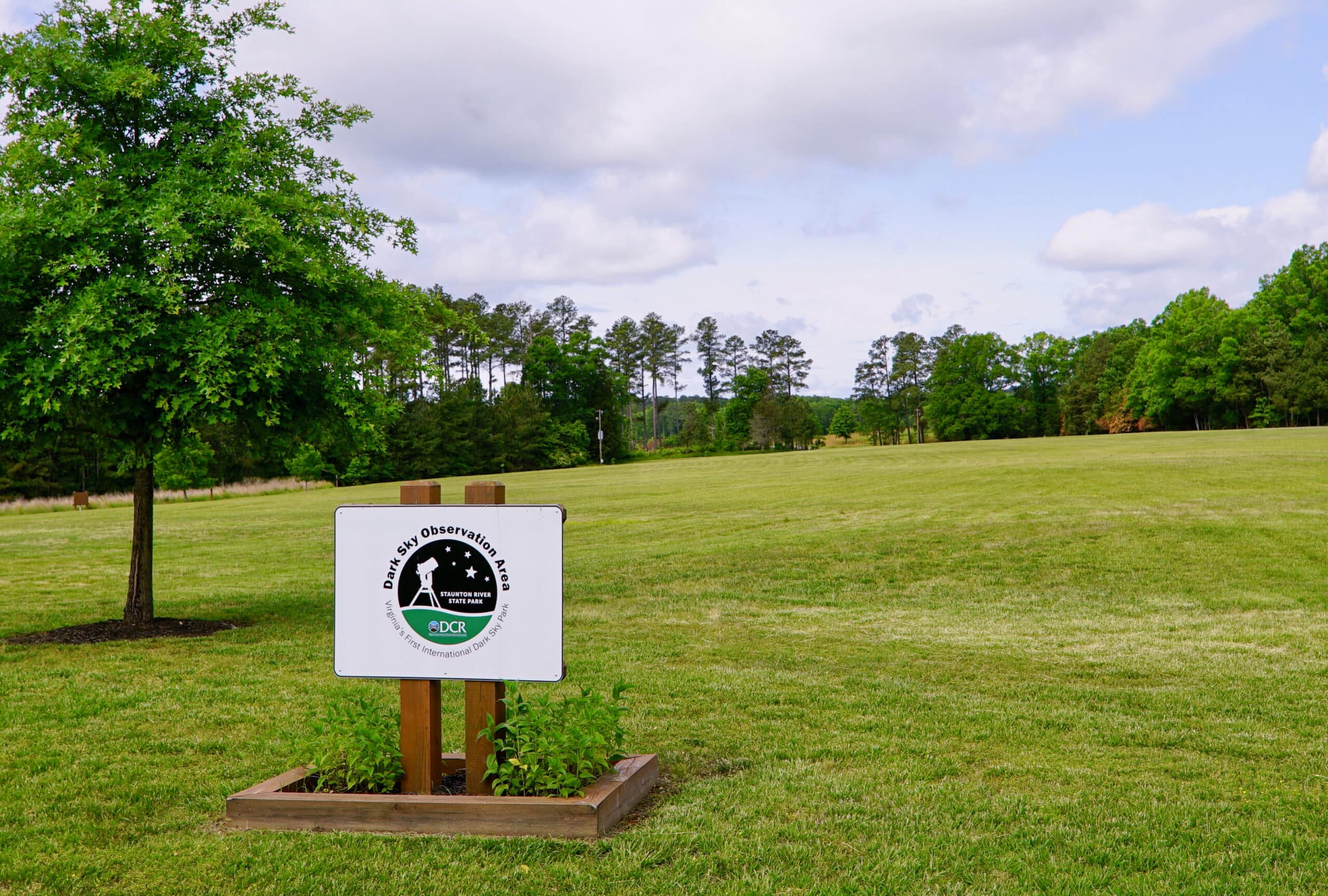 A sign in the middle of a grassy field at Staunton River State Park, Virginia.