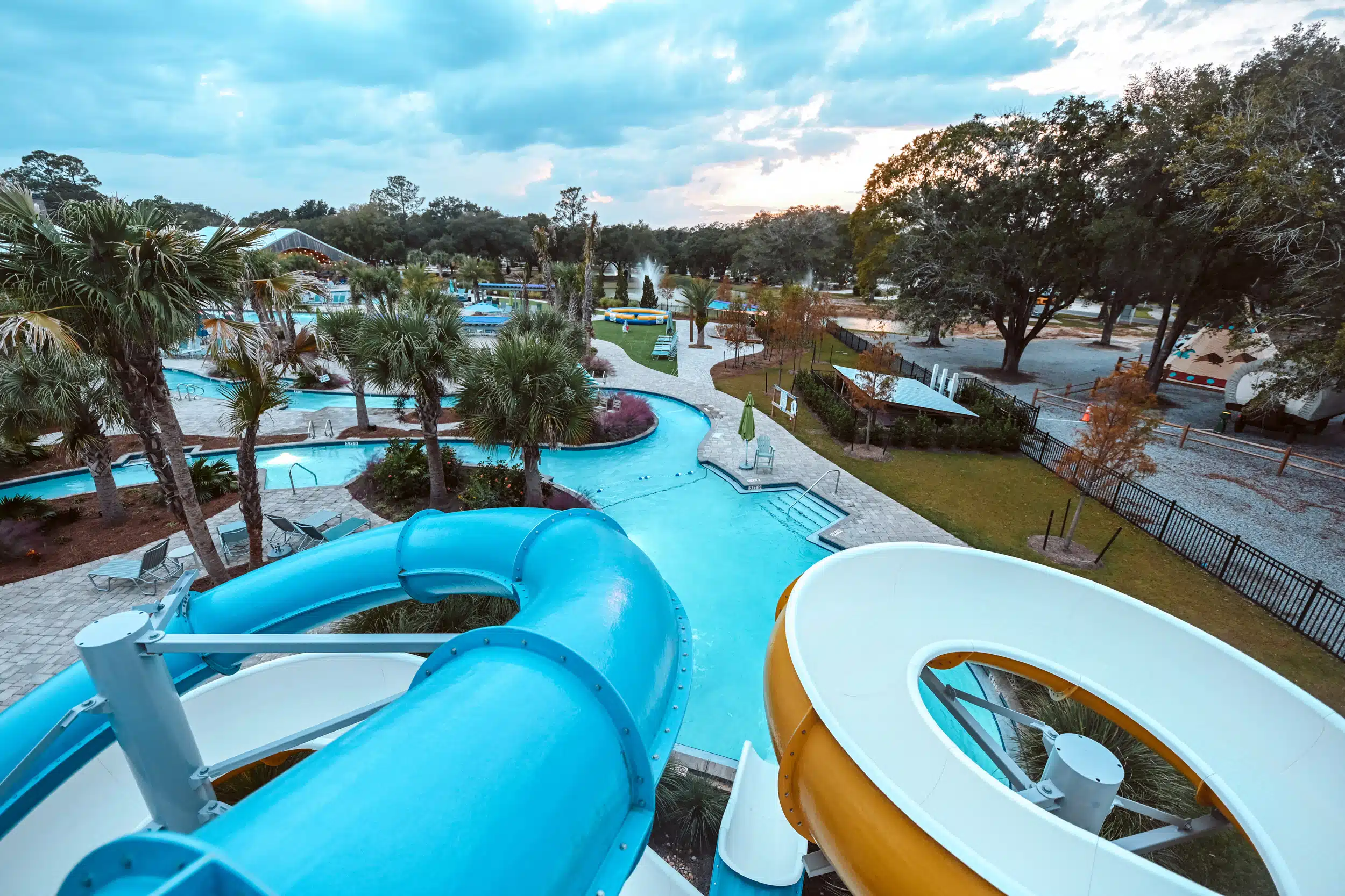 An aerial view of the Splash RV Resort and Waterpark, with luxurious cabins, at dusk.