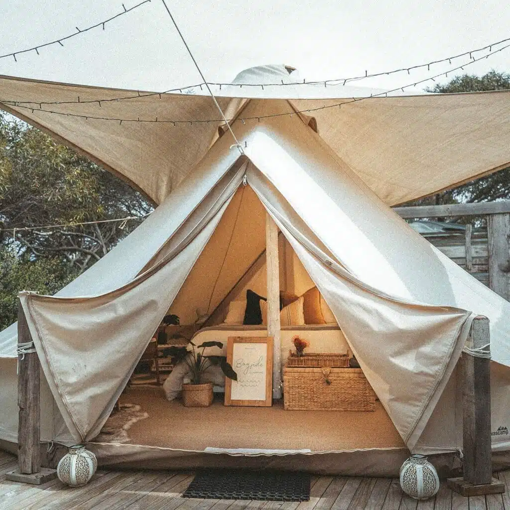 Luxury glamping getaway in South Australia featuring a canvas tent set up with cozy furnishings and string lights.