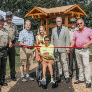 Tennessee State Parks leadership joined lawmakers and members of Achillies International to open a new accessible trail at Henry Horton State Park. L-R: Henry Horton State Park Manager Shaun Rainone, Tennessee State Parks Area Manager Jacob Young, Sen. Joey Hensley, Amy Harris, Sara “Lizzy” Harris, TDEC Deputy Commissioner Greer Tidwell, Tennessee State Parks Director of Operations Kim Moore, and Rep. Todd Warner.