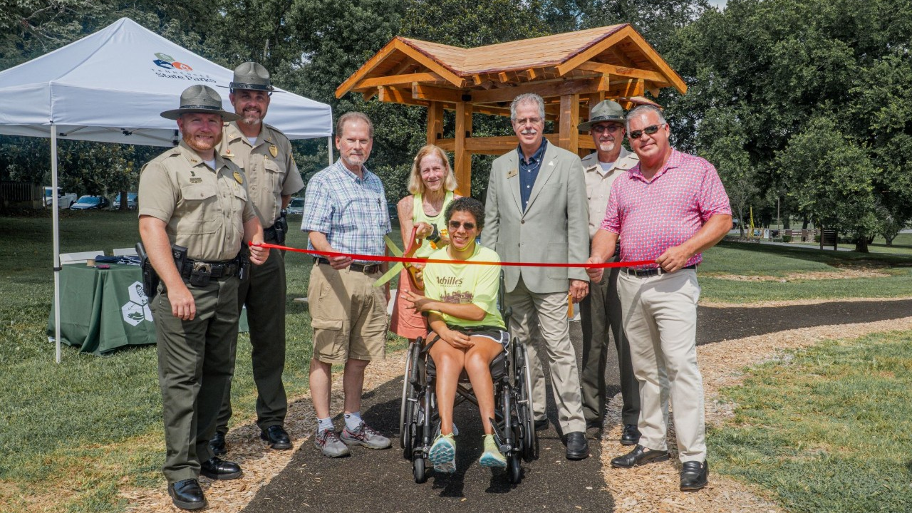 Tennessee State Parks leadership joined lawmakers and members of Achillies International to open a new accessible trail at Henry Horton State Park. L-R: Henry Horton State Park Manager Shaun Rainone, Tennessee State Parks Area Manager Jacob Young, Sen. Joey Hensley, Amy Harris, Sara “Lizzy” Harris, TDEC Deputy Commissioner Greer Tidwell, Tennessee State Parks Director of Operations Kim Moore, and Rep. Todd Warner.